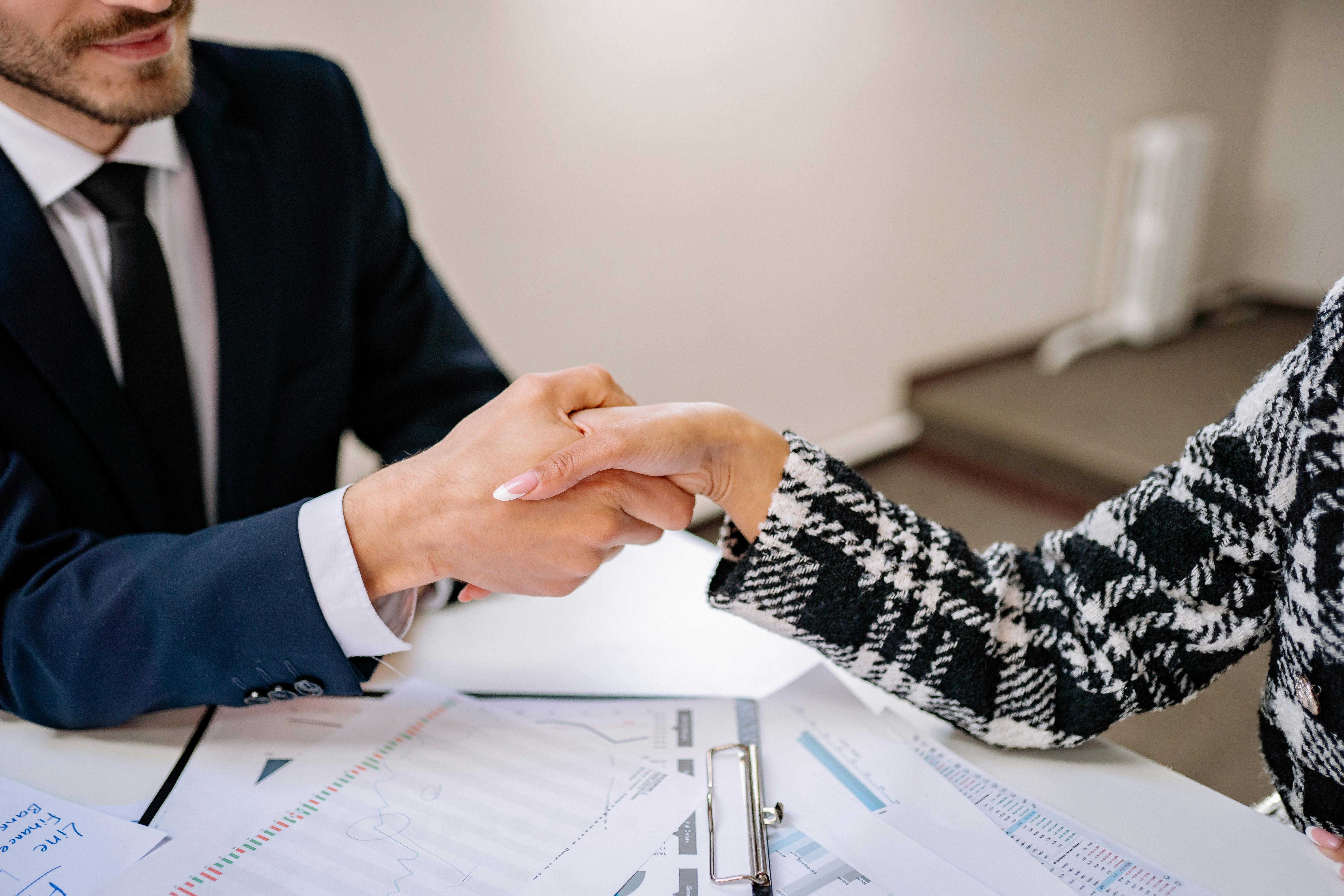Salesperson closing car deal with happy customer